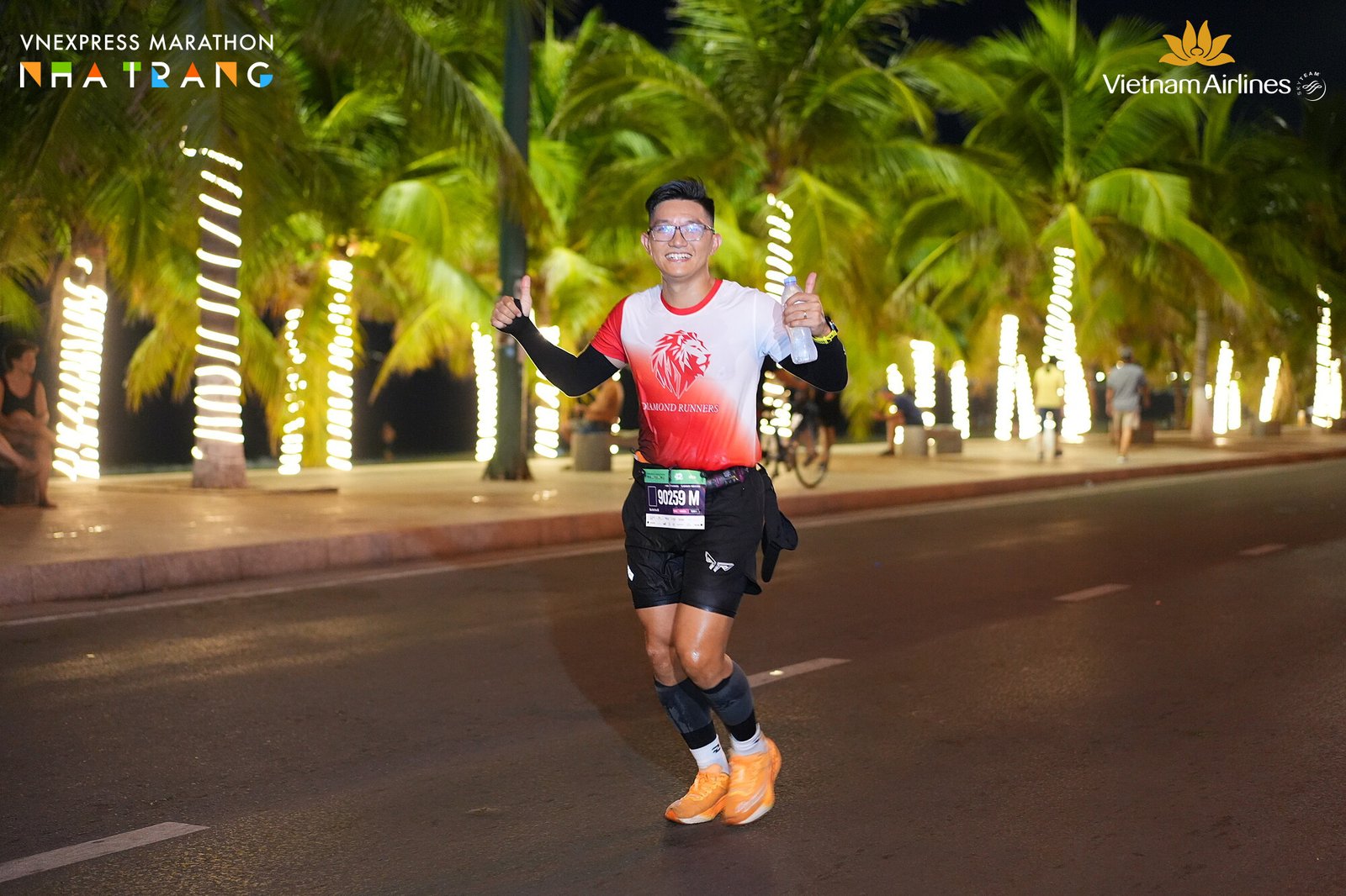Phạm Đức Anh chạy ban đêm dưới hàng đèn công viên bờ biển Nha Trang